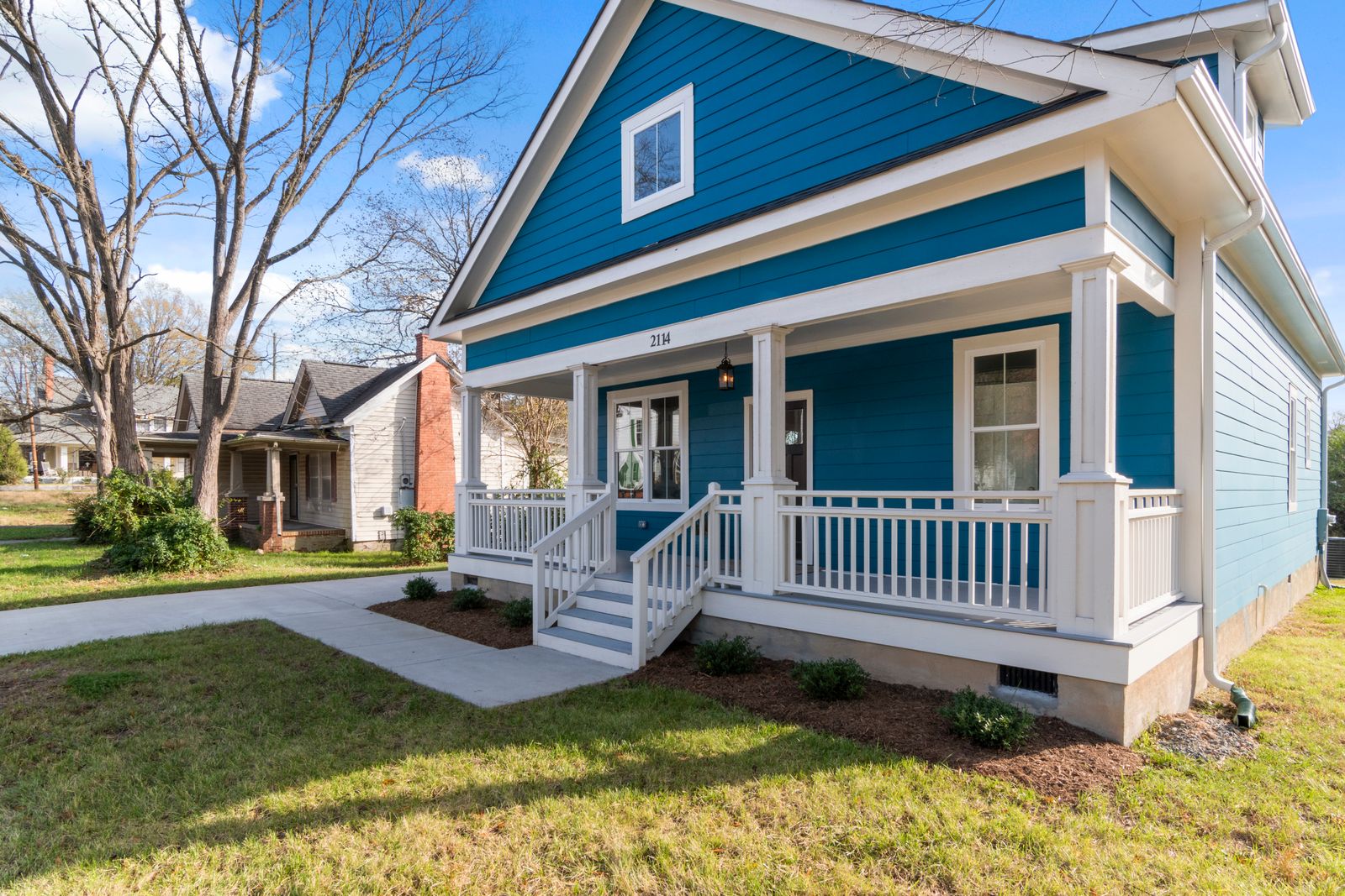 Blue coastal style home with white porch typical of Wilmington NC neighborhoods served by Timely Plumber