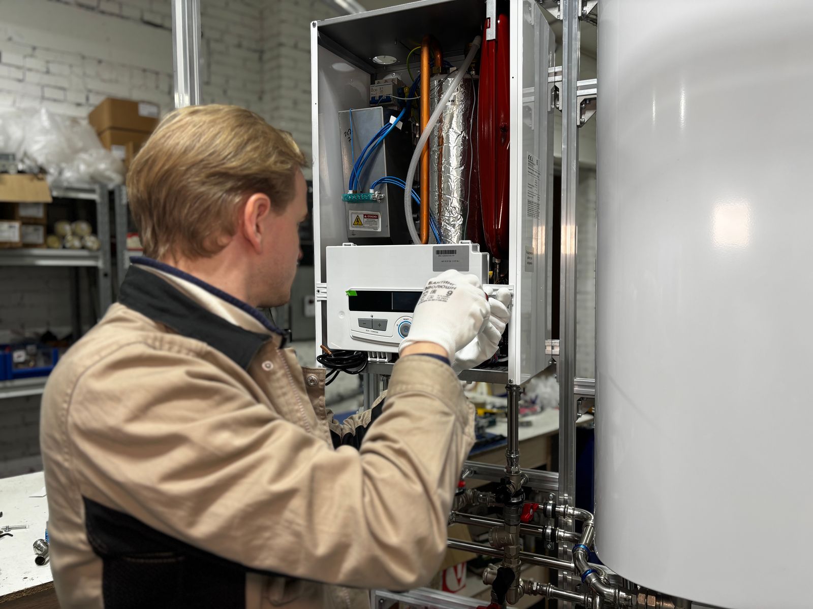 Technician installing a replacement water heater in a Wilmington NC home utility room